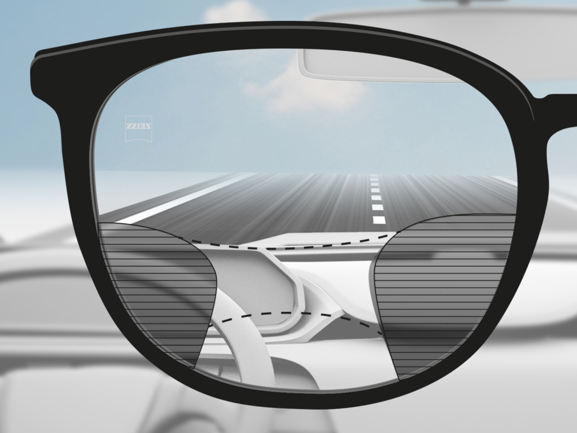 Een beeld door een ZEISS progressief DriveSafe brillenglas: De zichtzones zijn aangepast zodat de bestuurder duidelijk zicht op de weg en het dashboard heeft.