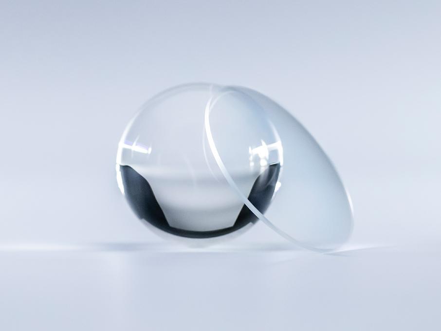Een brillenglas met ZEISS Platinum coating is kristalhelder zonder reflecties in vergelijking met de glazen bol ernaast.