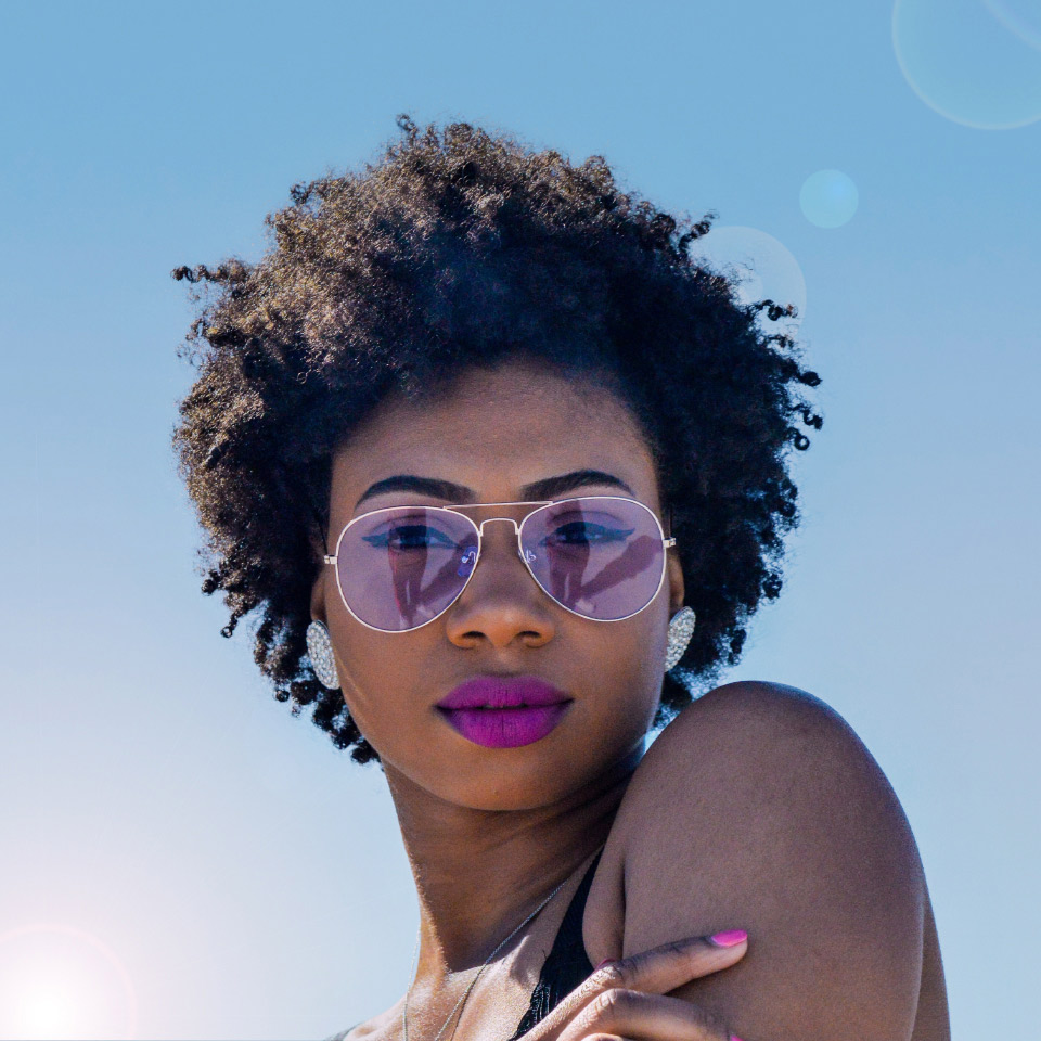 Women looking down and wearing purple tinted sunglasses.